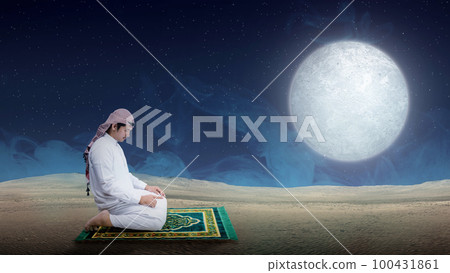 Muslim man with keffiyeh and agal in praying position (salat) on the prayer rug Muslim man with keffiyeh and agal in praying position (salat) on the prayer rug 100431861