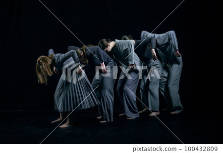 Inner chaos and self-expression. Group of young people dancing contemp against black studio background. Concept of contemporary dance 100432809