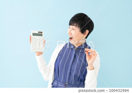 Surprised woman calculator money Surprised woman calculator money 100432994