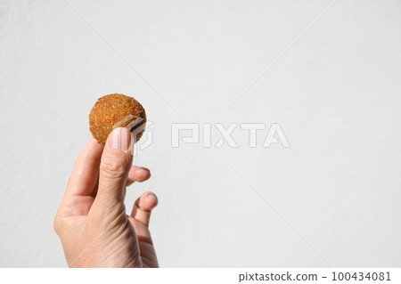 Authentic Sri Lankan cutlets snack street foods, short eats in female hand Authentic Sri Lankan cutlets snack street foods, short eats in female hand 100434081
