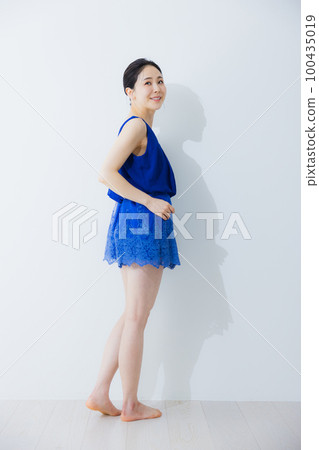 A woman in a blue dress A woman in a blue dress 100435019