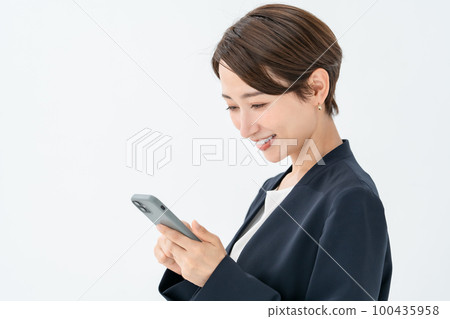 A woman operating a smartphone 100435958