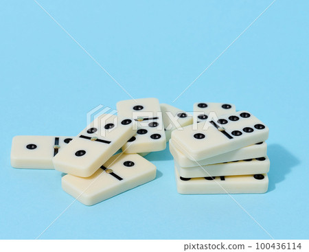 A stack of dominoes on a blue background, an intellectual game A stack of dominoes on a blue background, an intellectual game 100436114