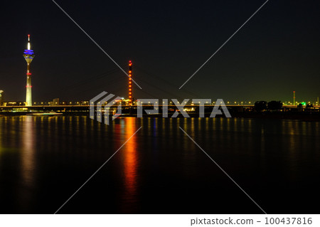 TV tower reflecting on Rhine River at night in Duesseldorf, Germany 100437816