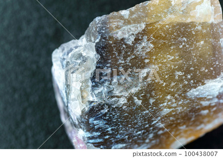 Raw fluorite mineral stone, natural minerals. Mineral fluorite translucent stone. Close up macro 100438007
