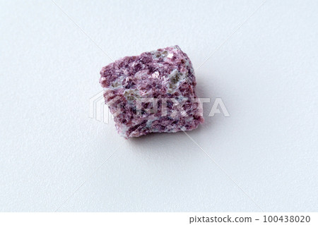 Lepidolite stone on a white background, being a secondary source of lithium, used in batteries 100438020