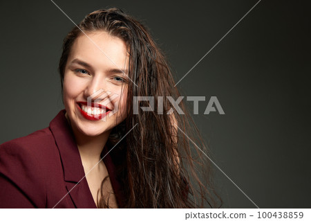 Fashionable stylish emotional woman wearing business style jacket posing over gray background. Concept of fashion, style, youth, beauty Fashionable stylish emotional woman wearing business style jacket posing over gray background. Concept of fashion, style, youth, beauty 100438859