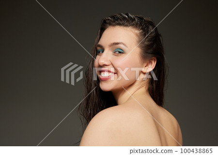 Half-length portrait of young emotional beautiful girl looking at camera isolated over grey background. Beauty, fashion, style, fun and joy concept Half-length portrait of young emotional beautiful girl looking at camera isolated over grey background. Beauty, fashion, style, fun and joy concept 100438865