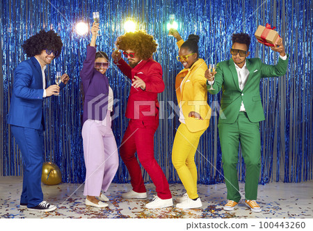 A modern dance group of five adult young people in multi-colored costumes is dancing incendiary. 100443260