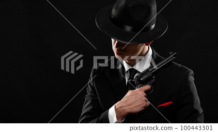 Gangster from 1940s with a gun. Photo with a copy space. Gangster from 1940s with a gun. Photo with a copy space. 100443301