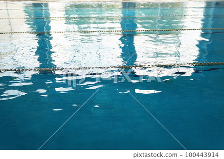 A swimming pool prepared for training without people. Clear blue water with dividing lines for swimming. With space to copy. High quality photo 100443914