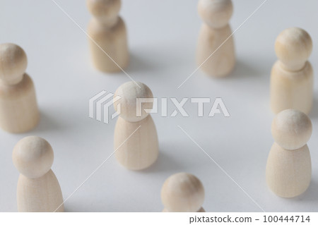 Female and male wooden figures are scattered on white background. 100444714