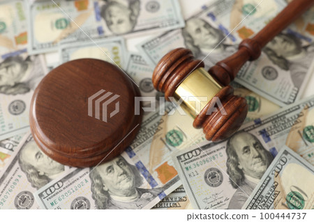 Judge gavel on dollar banknotes background. Judge gavel on dollar banknotes background. 100444737