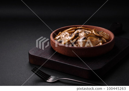 Fried or stewed champignon mushrooms in the form of slices with onions Fried or stewed champignon mushrooms in the form of slices with onions 100445263