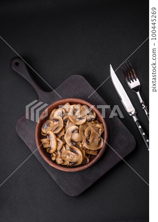 Fried or stewed champignon mushrooms in the form of slices with onions 100445269