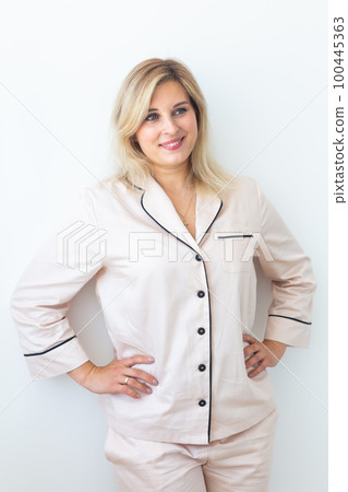 Fun minded woman wear pajama rest relax spend time in living room lounge home in own room hotel wake up 100445363