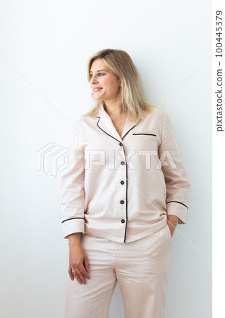 Fun minded woman wear pajama rest relax spend time in living room lounge home in own room hotel wake up 100445379