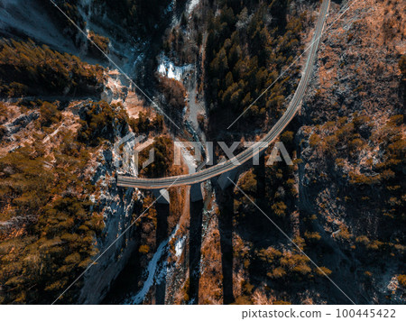 Aerial view famous mountain in Filisur, Switzerland. Landwasser Viaduct - world heritage with train Glacier express in Swiss Alps. Aerial view famous mountain in Filisur, Switzerland. Landwasser Viaduct - world heritage with train Glacier express in Swiss Alps. 100445422