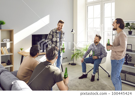 Men friends with beard at home talking and laughing with a beer. The concept of friendship. Men friends with beard at home talking and laughing with a beer. The concept of friendship. 100445424
