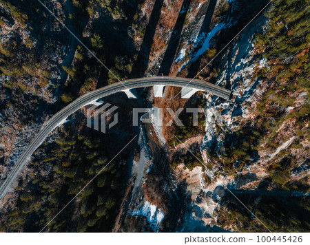 Aerial view famous mountain in Filisur, Switzerland. Landwasser Viaduct - world heritage with train Glacier express in Swiss Alps. 100445426