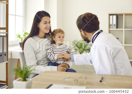 Mother with toddler baby visiting pediatrician in medical office. Mother with toddler baby visiting pediatrician in medical office. 100445432