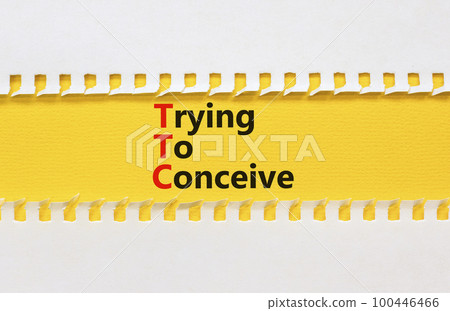 TTC trying to conceive symbol. Concept words TTC trying to conceive on yellow paper on a beautiful white paper background. Medical and TTC trying to conceive concept. Copy space. 100446466