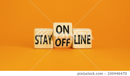 Stay online or offline symbol. Concept word Stay online or offline on wooden cubes. Beautiful orange table orange background. Business and stay online or offline concept. Copy space. Stay online or offline symbol. Concept word Stay online or offline on wooden cubes. Beautiful orange table orange background. Business and stay online or offline concept. Copy space. 100446470