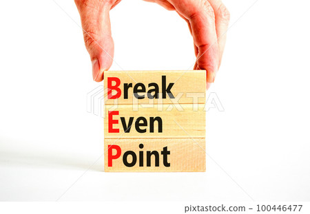 BEP break even point symbol. Concept words BEP break even point on wooden blocks on a beautiful white table white background. Businessman hand. Business and BEP break even point concept. Copy space. BEP break even point symbol. Concept words BEP break even point on wooden blocks on a beautiful white table white background. Businessman hand. Business and BEP break even point concept. Copy space. 100446477