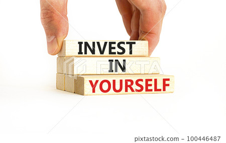 Invest in yourself symbol. Concept words Invest in yourself on wooden block on a beautiful white table white background. Businessman hand. Business and Invest in yourself concept. Copy space. 100446487