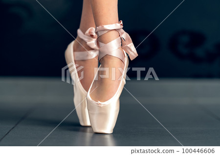 ballet shoes on the feet of a ballerina. close up 100446606