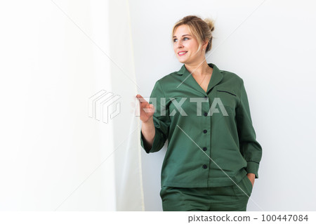Carefree young woman in cozy pajamas resting at home copy space - wellbeing and comfort morning concept 100447084