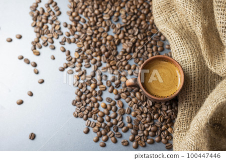 hot delicious aromatic coffee black espresso in a white cup on a background of coffee beans hot delicious aromatic coffee black espresso in a white cup on a background of coffee beans 100447446