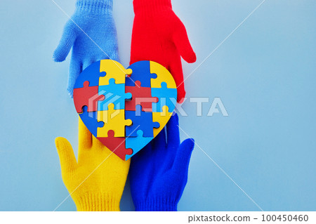 Hands holding jigsaw puzzle heart shape, Autism awareness, World Autism Awareness Day 100450460