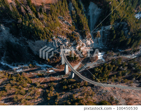 Aerial view famous mountain in Filisur, Switzerland. Landwasser Viaduct - world heritage with train Glacier express in Swiss Alps. Aerial view famous mountain in Filisur, Switzerland. Landwasser Viaduct - world heritage with train Glacier express in Swiss Alps. 100450530
