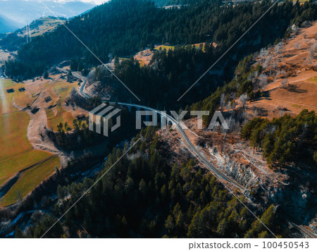 Aerial view famous mountain in Filisur, Switzerland. Landwasser Viaduct - world heritage with train Glacier express in Swiss Alps. 100450543