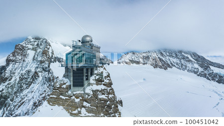 Aerial panorama view of the Sphinx Observatory on Jungfraujoch - Top of Europe, one of the highest observatories in the world located at the Jungfrau railway station, Bernese Oberland, Switzerland. 100451042
