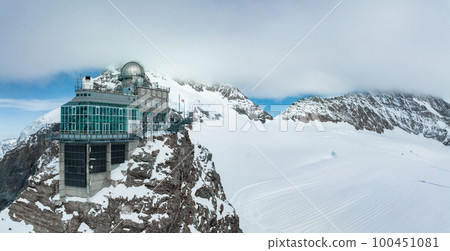 Aerial panorama view of the Sphinx Observatory on Jungfraujoch - Top of Europe, one of the highest observatories in the world located at the Jungfrau railway station, Bernese Oberland, Switzerland. 100451081
