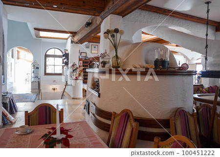 Interior of luxury hotel with flower vase and various decor on shelf over fireplace Interior of luxury hotel with flower vase and various decor on shelf over fireplace 100451222