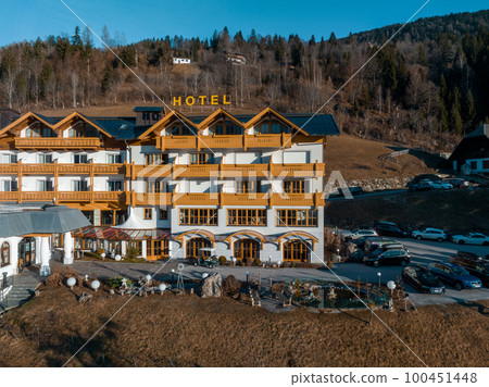 Beautiful luxury Alpine hotel on top of the mountain during spring time. Holiday concept view. 100451448