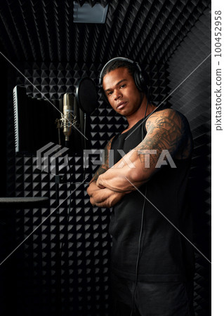 African American at the recording studio in headphones reads rap African American at the recording studio in headphones reads rap 100452958