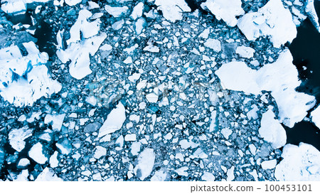 Melting Arctic ice in ocean water. Snow covered Blue glacier ice in Iceland. Global warming and climate crisis. Pure antarctic landscape aerial view. Melting Arctic ice in ocean water. Snow covered Blue glacier ice in Iceland. Global warming and climate crisis. Pure antarctic landscape aerial view. 100453101