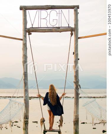 girl on a swing overlooking the sea girl on a swing overlooking the sea 100453970