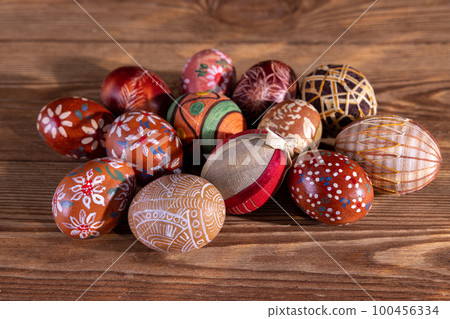A collection of Easter eggs with brown colors lying on old boards. A collection of Easter eggs with brown colors lying on old boards. 100456334