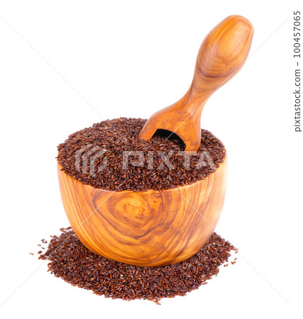 Psyllium seeds in wooden bowl and spoon, isolated on white background. Plantain. Plantago psyllium. 100457065