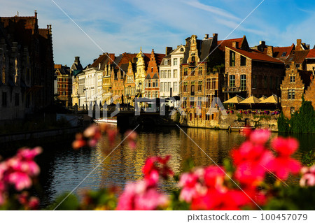 Medieval buildings in historical center of Ghent reflecting in water of river Leie Flanders 100457079