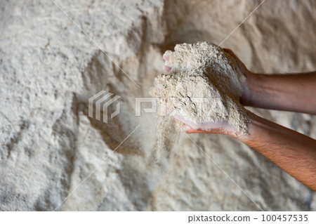 Closeup of handful of soy flour in male hands 100457535