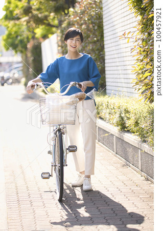 Young woman going shopping by bicycle 100457921