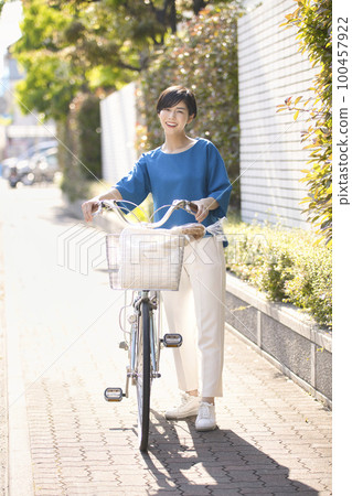 Young woman going shopping by bicycle 100457922