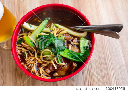 Beef soup with noodles 100457956