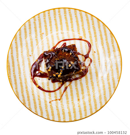 Traditional spanish dessert Tarta de zanahoria. Slice of carrot cake with chocolate syrup Traditional spanish dessert Tarta de zanahoria. Slice of carrot cake with chocolate syrup 100458132